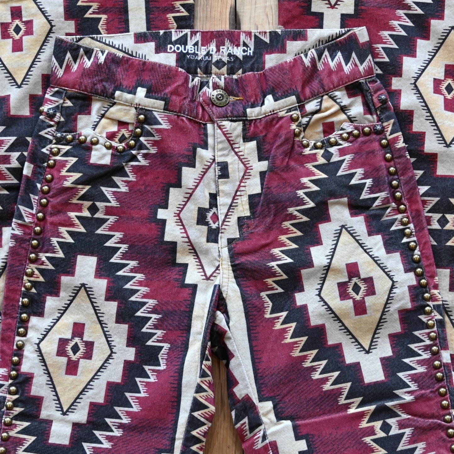 View of Double D Ranch Left Behind Pants – Traditional rug pattern with brass accents for a Western-inspired design