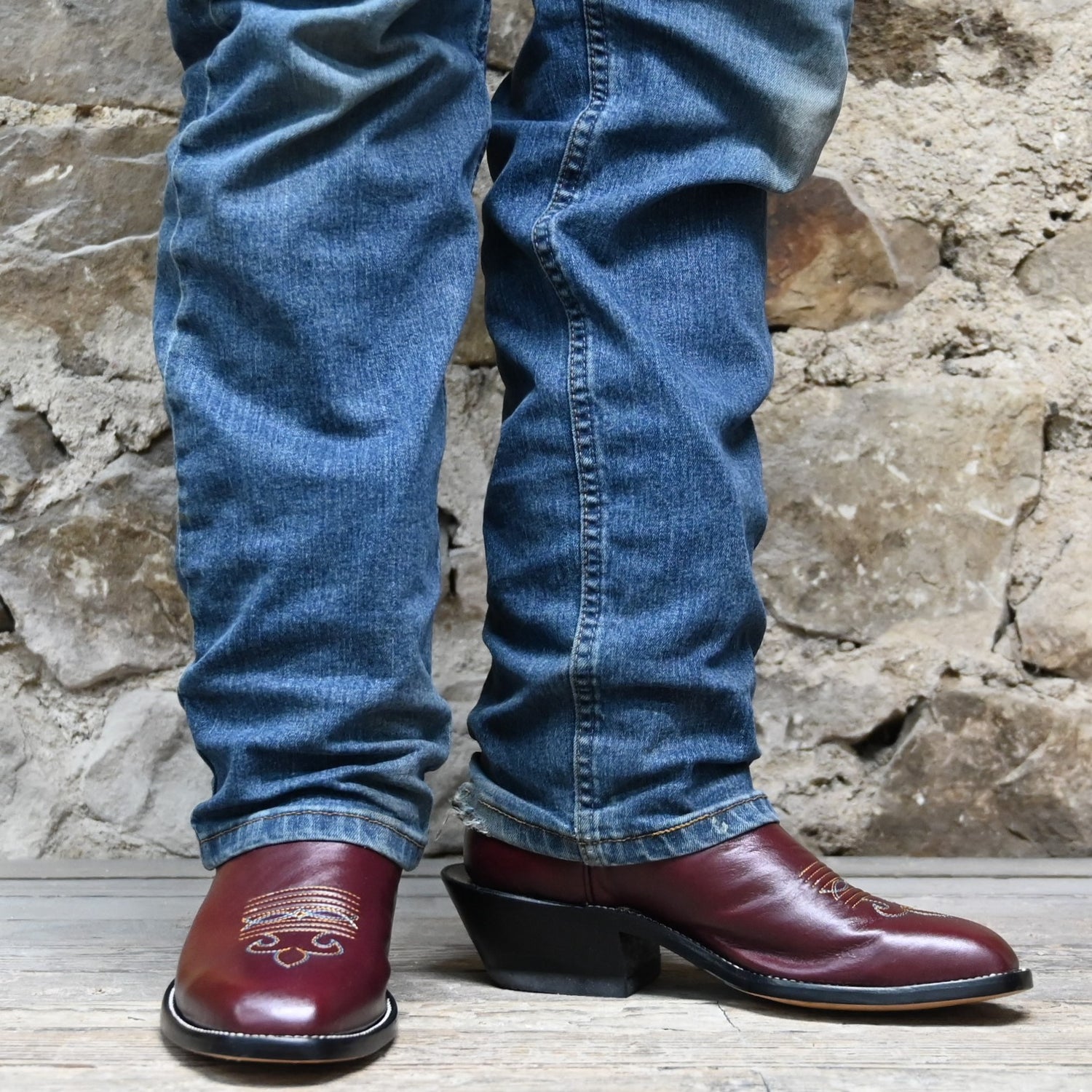 View of Atomic 79 exclusive Hondo Bronc Boot with black top, burgundy vamp, French square toe, and spur lip