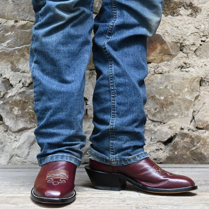 View of Atomic 79 exclusive Hondo Bronc Boot with black top, burgundy vamp, French square toe, and spur lip