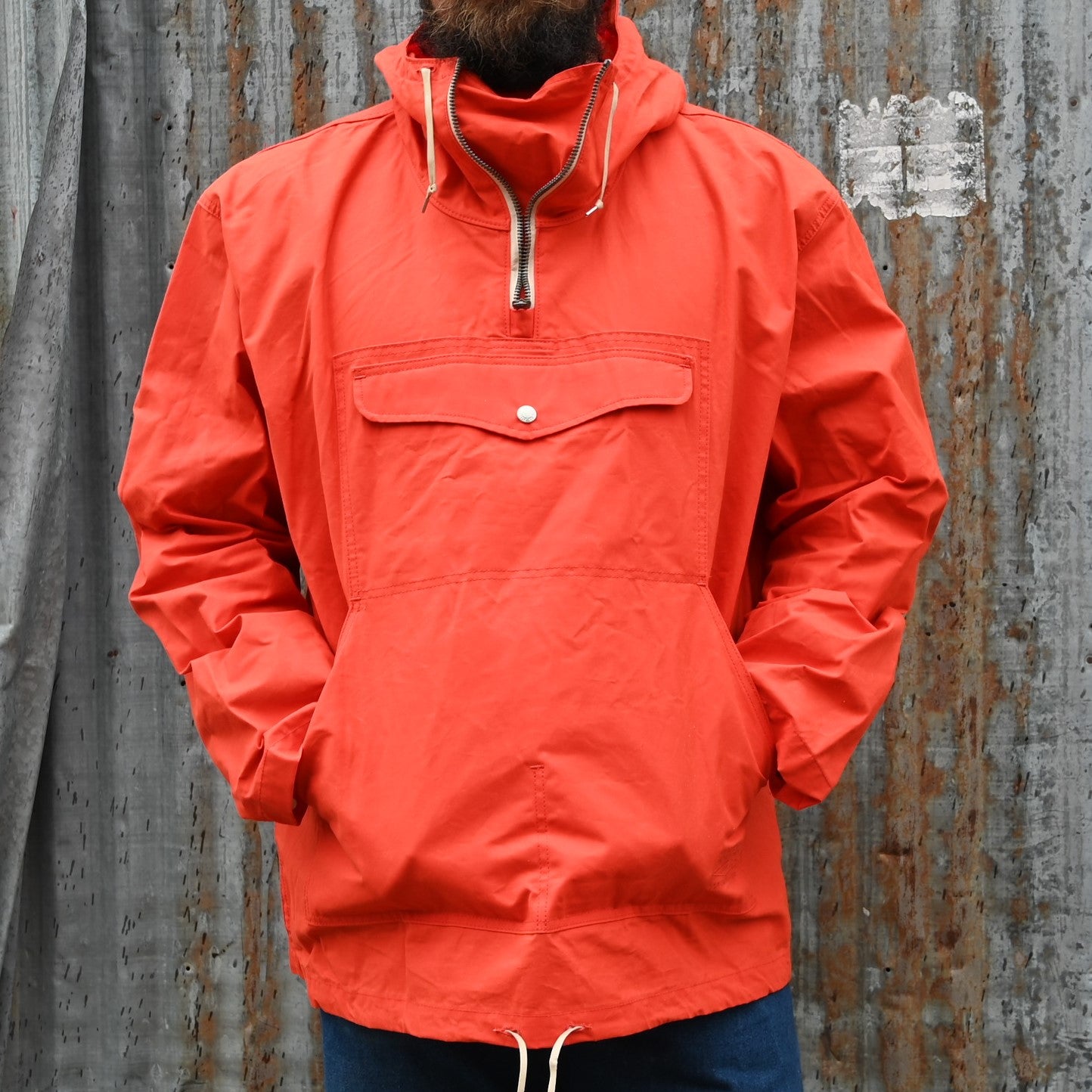 View of Filson Ranger Anorak Pullover – EX Orange, showcasing adjustable features and multiple pockets for outdoor utility