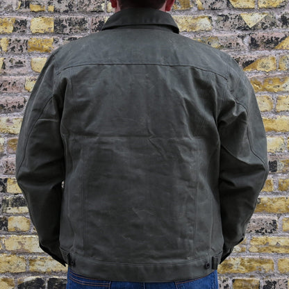 View of Filson Tin Cloth Short Lined Cruiser Jacket in Assorted Colors, showcasing durable waxed cotton exterior and adjustable cuffs and hem