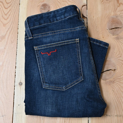 View of Kimes Ranch Chloe Jeans in Blue, featuring a mid-rise waist, fitted thigh, and flare bootcut leg with hand-sanded details
