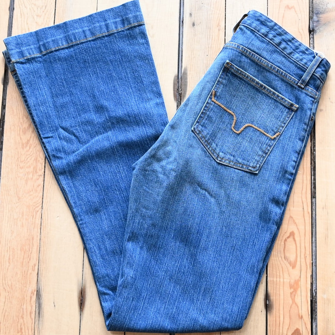 View of Kimes Ranch Jennifer Jeans in Mid Wash featuring a super wide flare leg with hand-sanding and whisker details