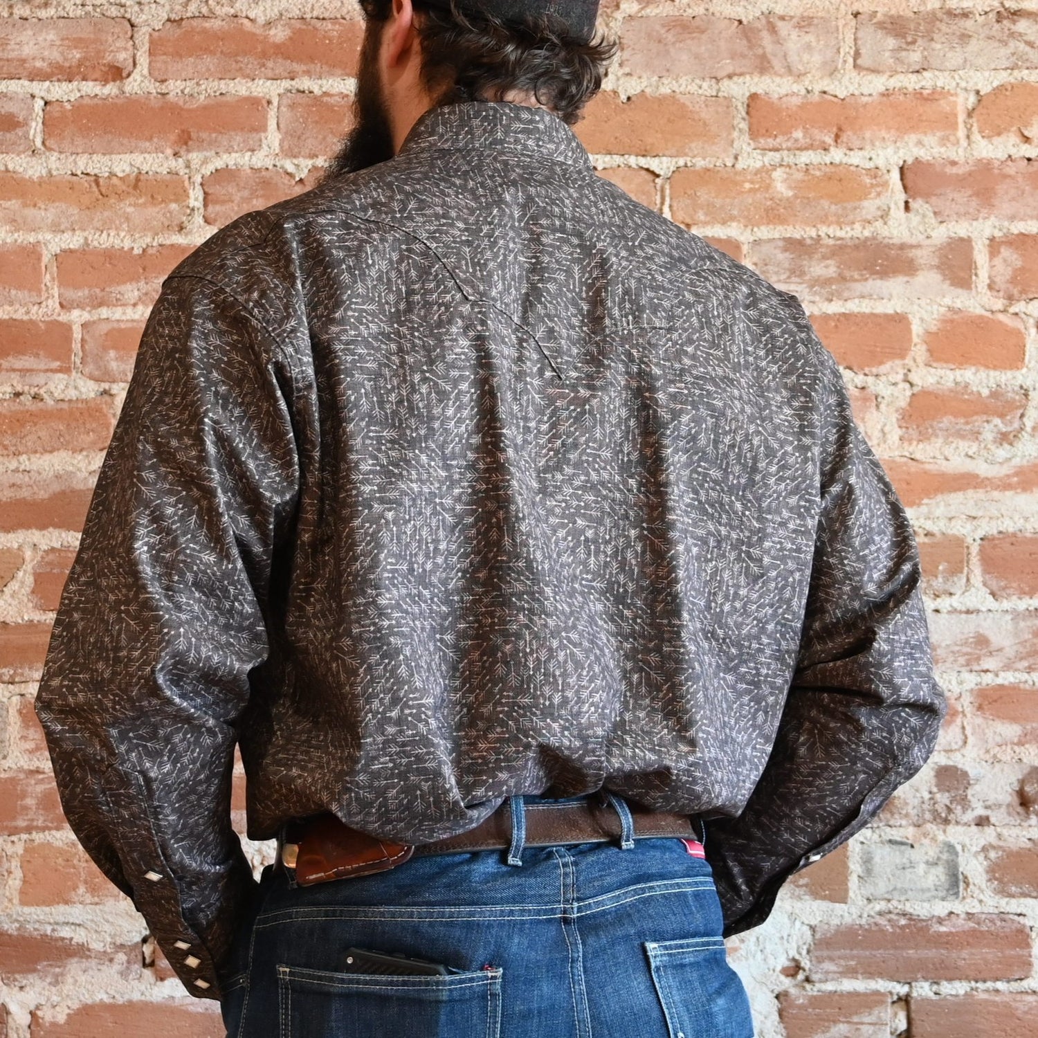 View of Rockmount greige western shirt with arrow print, sawtooth pockets, and diamond snaps