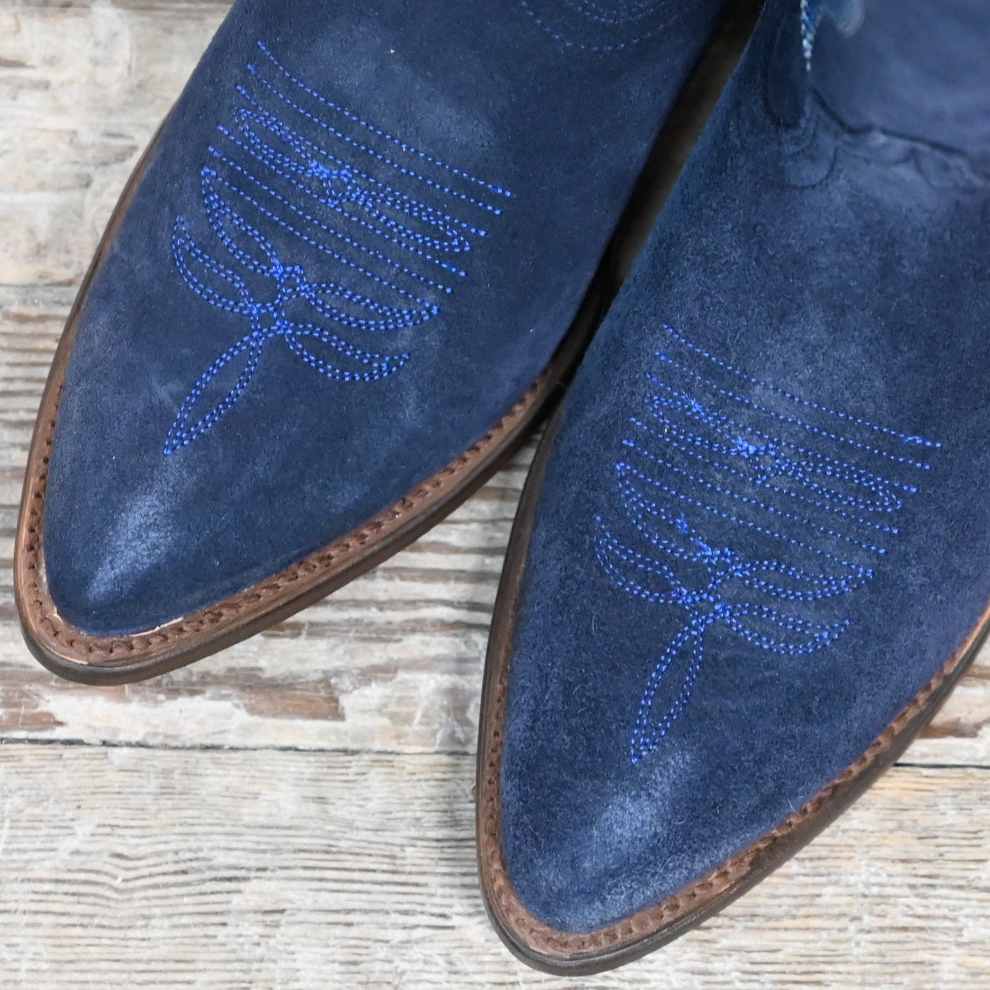 View of Macie Bean 15″ “Midnight In Paris” boot in marine blue suede with almond toe and cowgirl heel