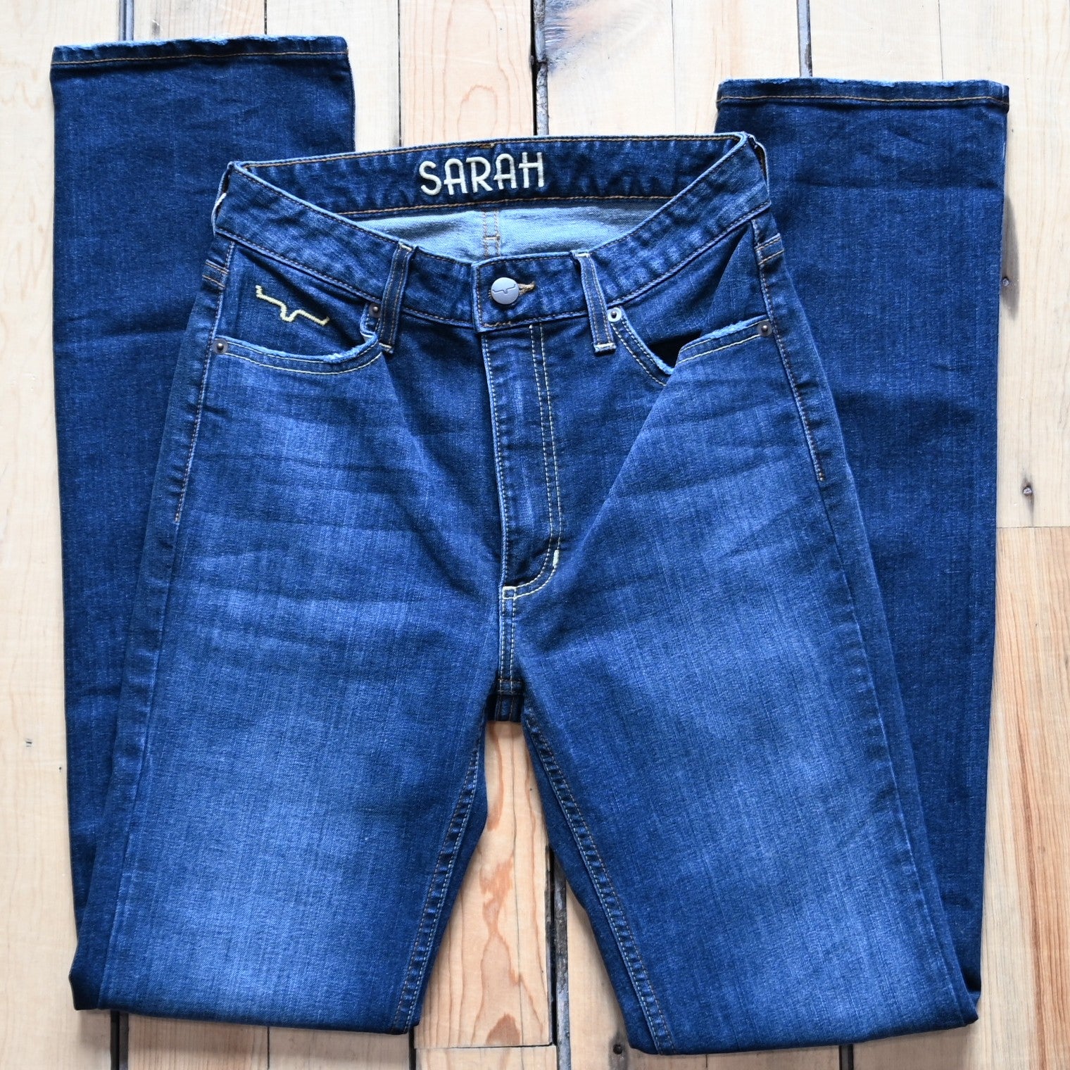 View of Kimes Ranch Sarah Jean in Blue Wash featuring high-rise waist, slim bootcut leg, and Longhorn logo