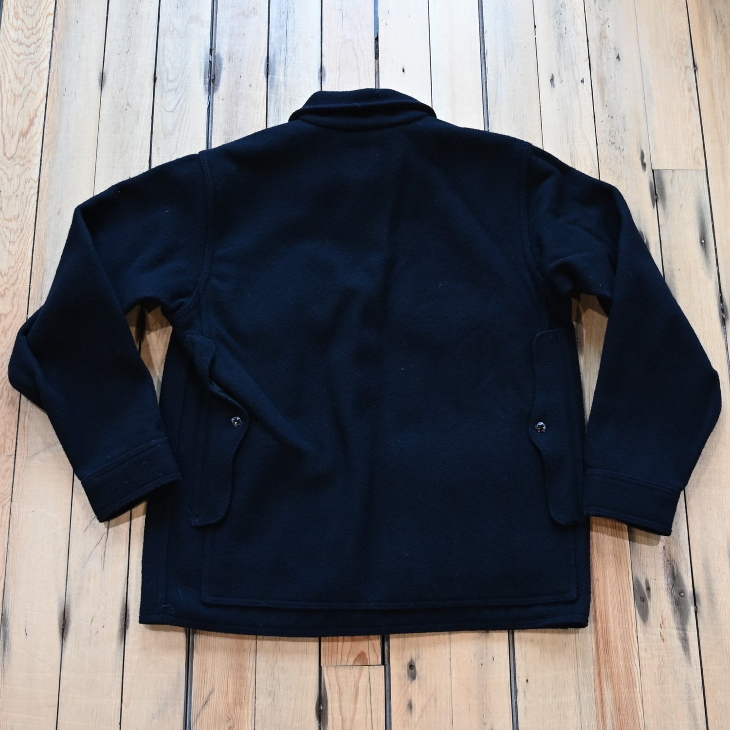 View of Filson Mackinaw Cruiser in Navy, Charcoal &amp; Natural/Black Heritage Plaid featuring button-secure front closure, adjustable cuffs, and multiple pockets