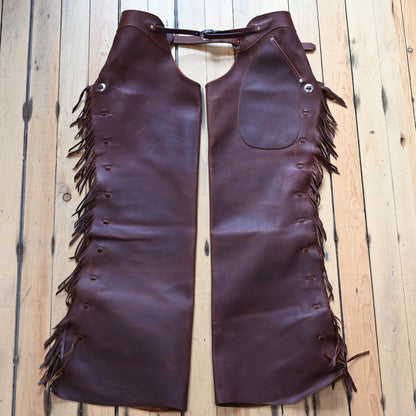 View of K Bar J Cowboy Basic Shotgun Chaps in Size Large with fringe and buckle closures