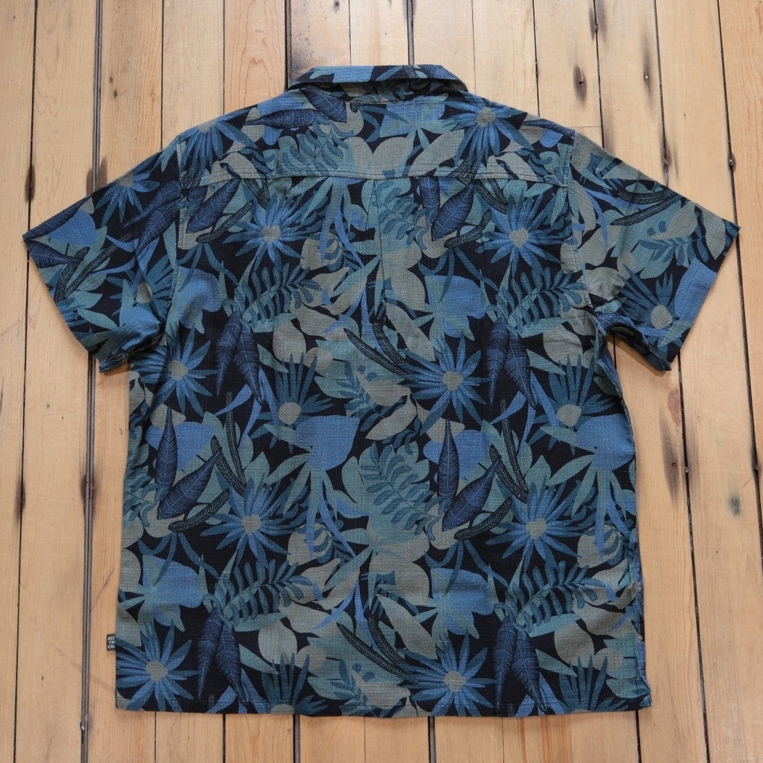 Howler Bros Shores Club Shirt in Tropical Dimension: Antique Black laid flat.
