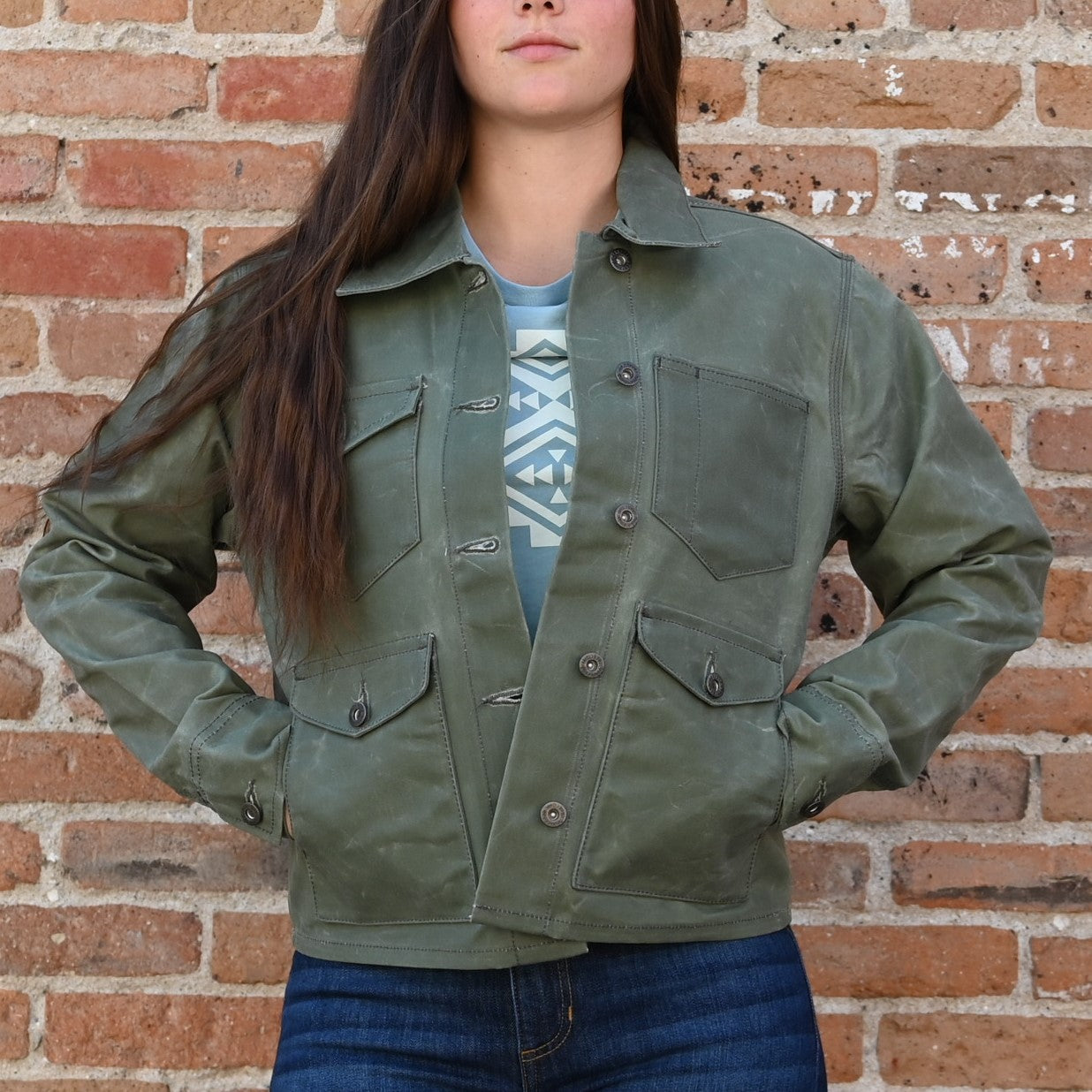 View of Schaefer ladies moss waxed canvas jacket with antique brass snaps and six pockets