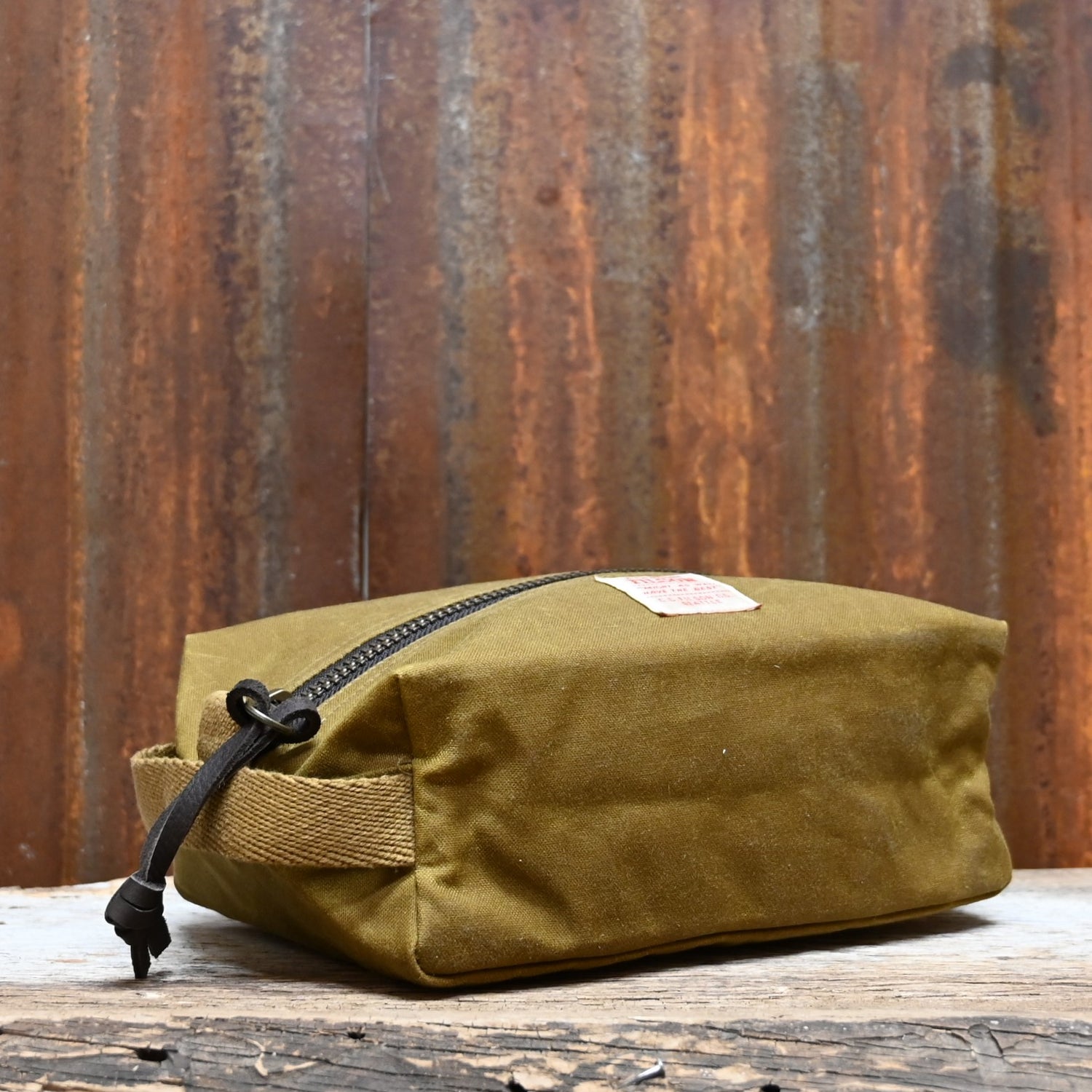View of Filson Tin Cloth Travel Kit in Dark Tan, showcasing durable waxed cotton exterior and practical design for travel essentials