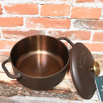 View of Smithey Ironware 5.5 qt Dutch Oven with polished interior and ergonomic handles