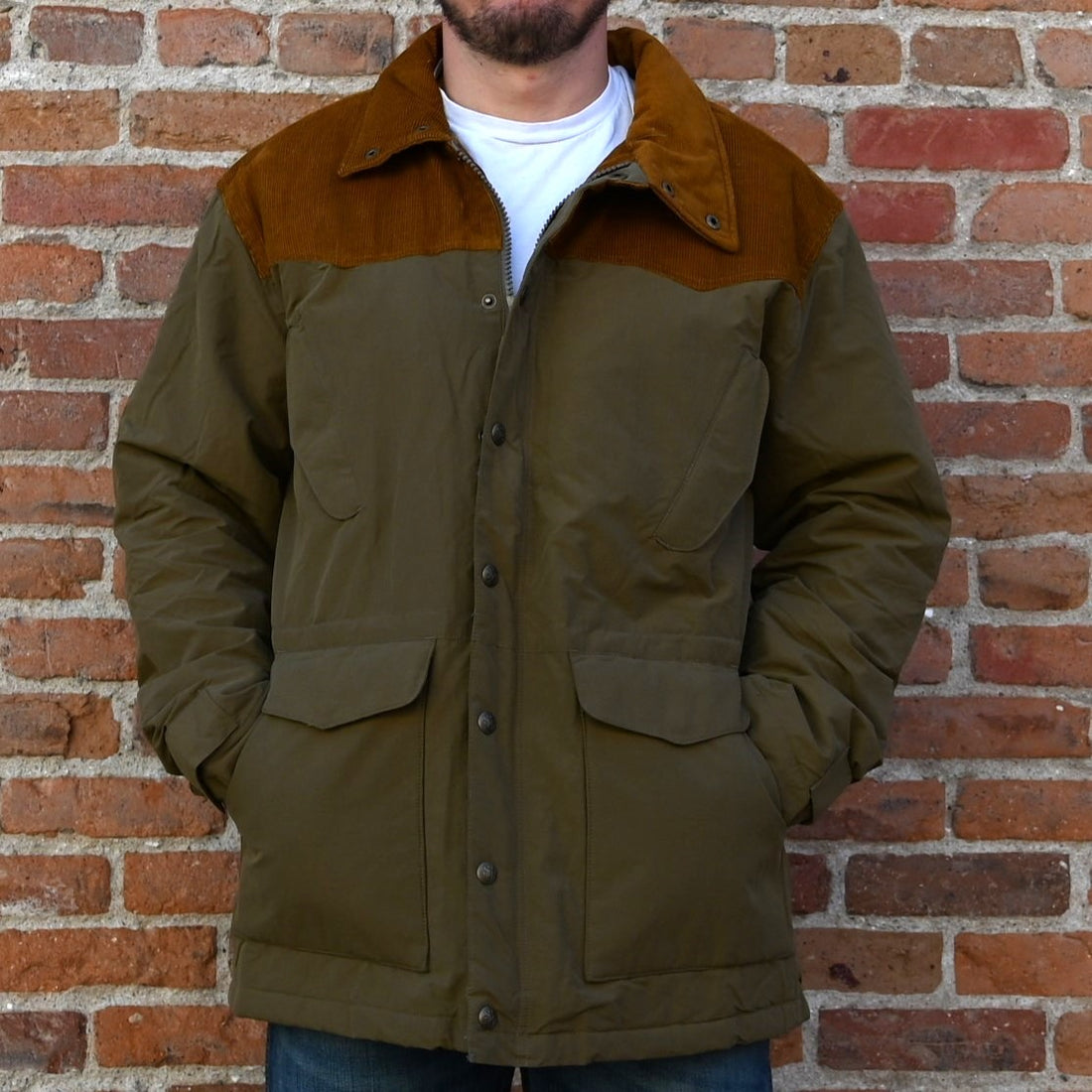 View of Schaefer Carson olive jacket with corduroy yoke and collar, quilted lining, and multiple utility pockets