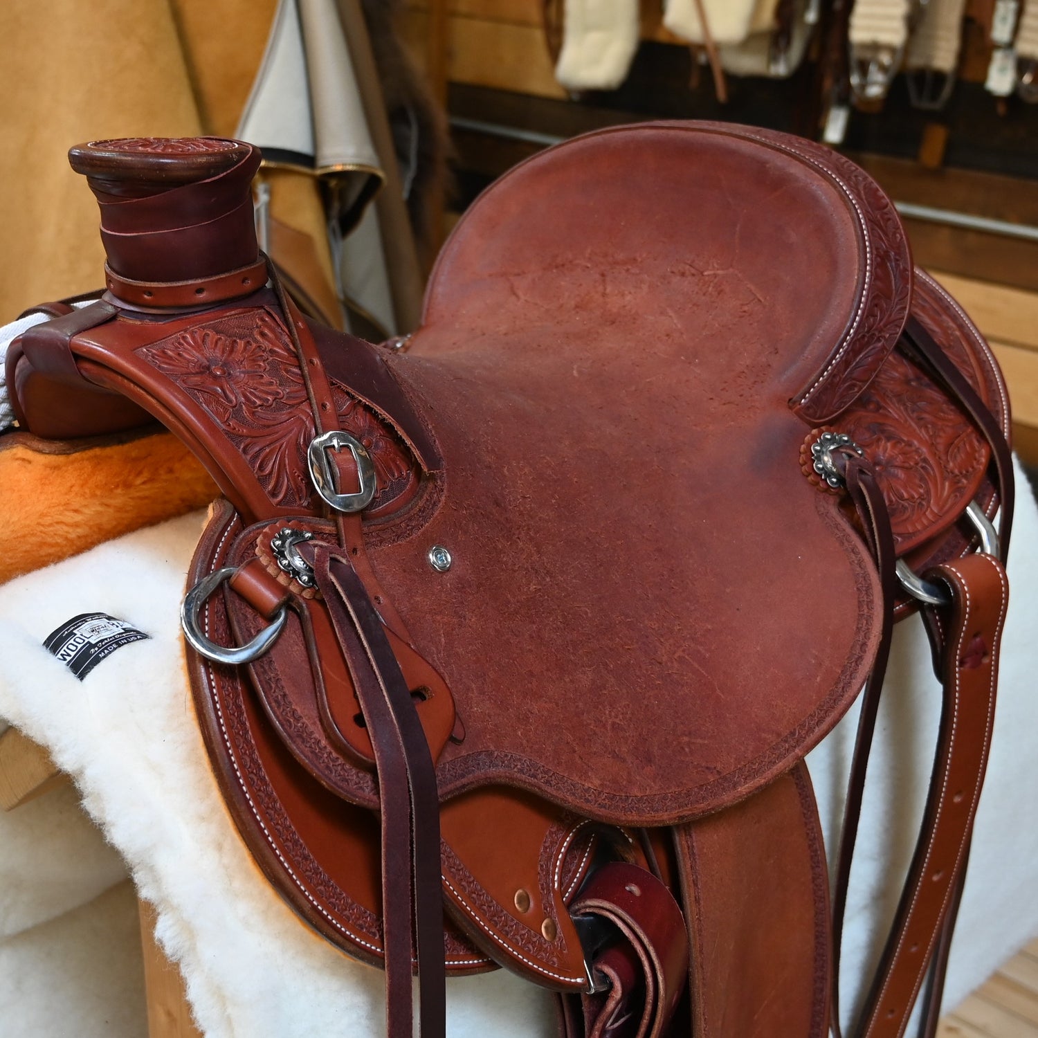 View of Deeter 3B Visalia Chestnut Saddle with floral border tooling