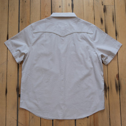 Howler Bros Broncbuster short-sleeve snapshirt in Sand with contrast piping.
