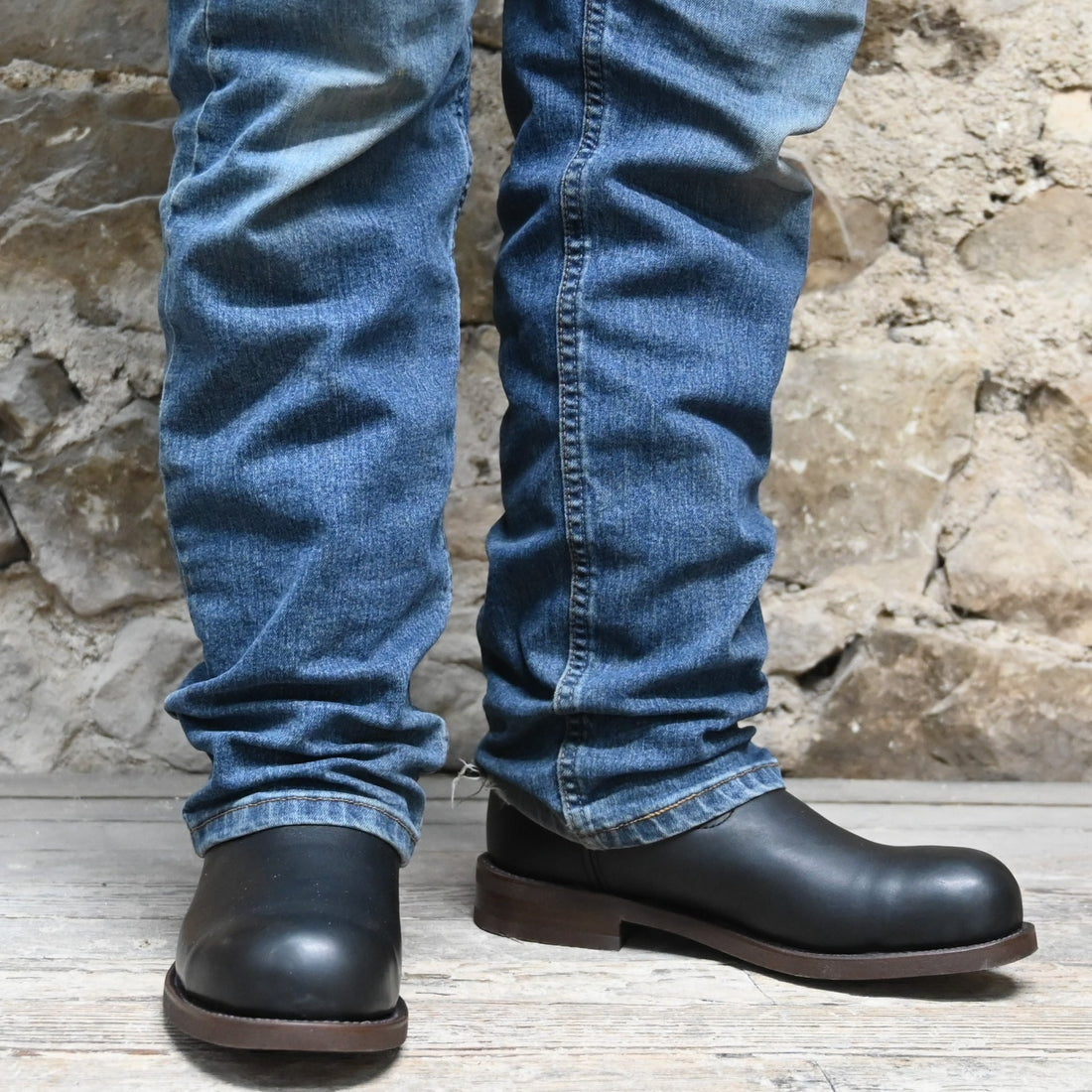 Nutted Calf Trucker in Black with Steel Toe view of front and side on model size 10.5