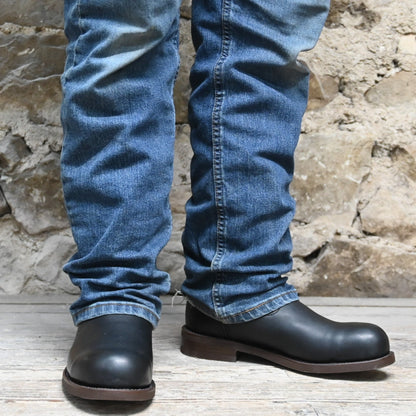 Nutted Calf Trucker in Black with Steel Toe view of front and side on model size 10.5