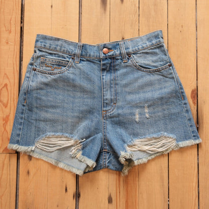 Kimes Ranch Daisy high-rise denim shorts in medium wash with raw hem.