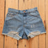 Kimes Ranch Daisy high-rise denim shorts in medium wash with raw hem.