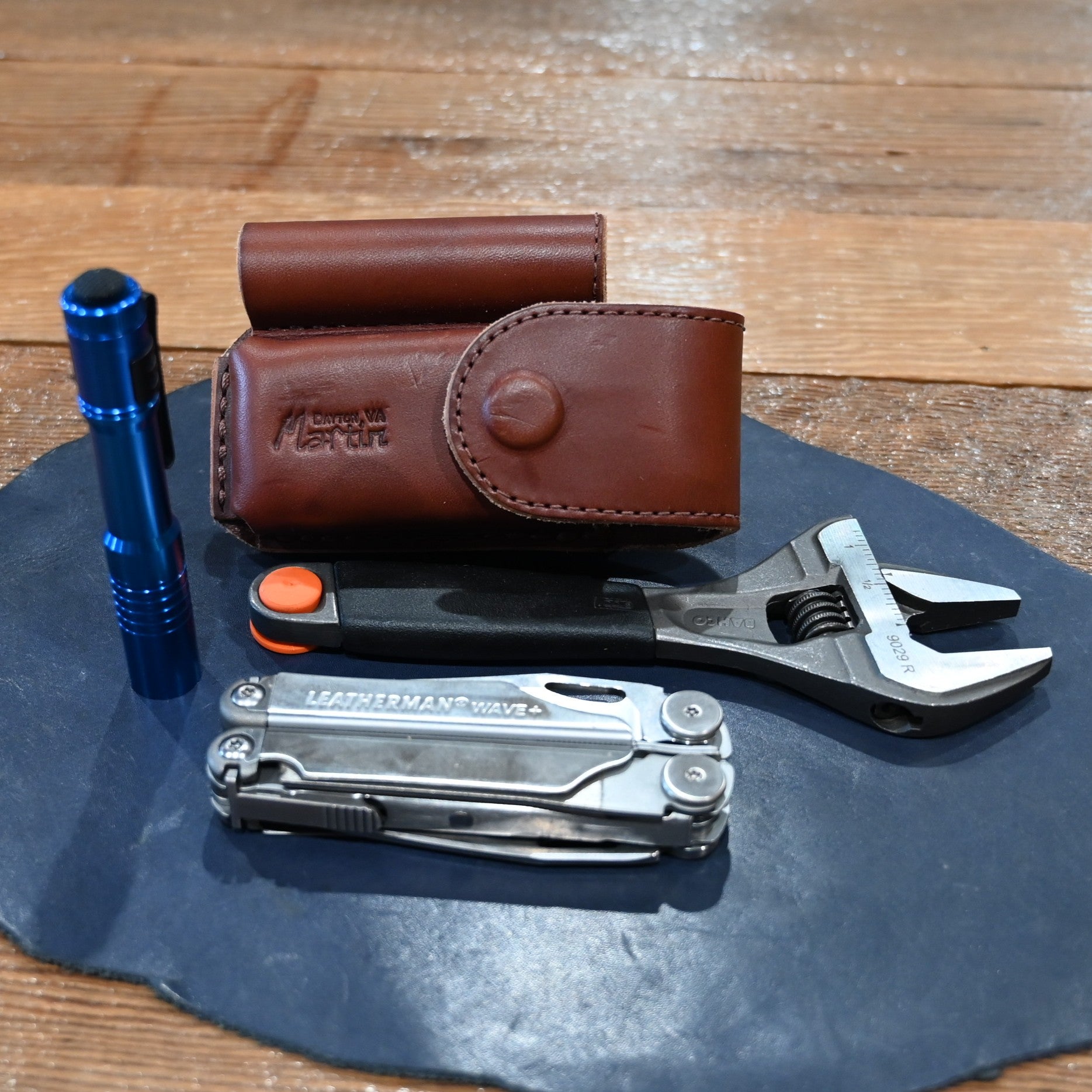 Martin harness leather case with flashlight, wrench, and Wave Leatherman tool combo