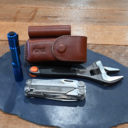 Martin harness leather case with flashlight, wrench, and Wave Leatherman tool combo