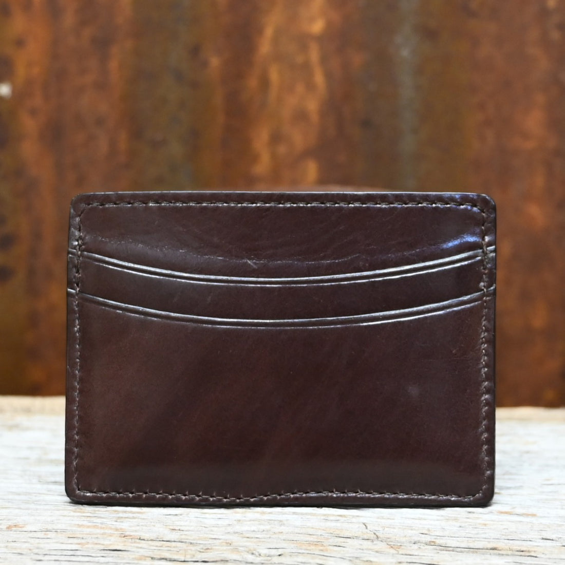 View of Lucchese brown leather credit card case with contrast stitching and slim, flat design