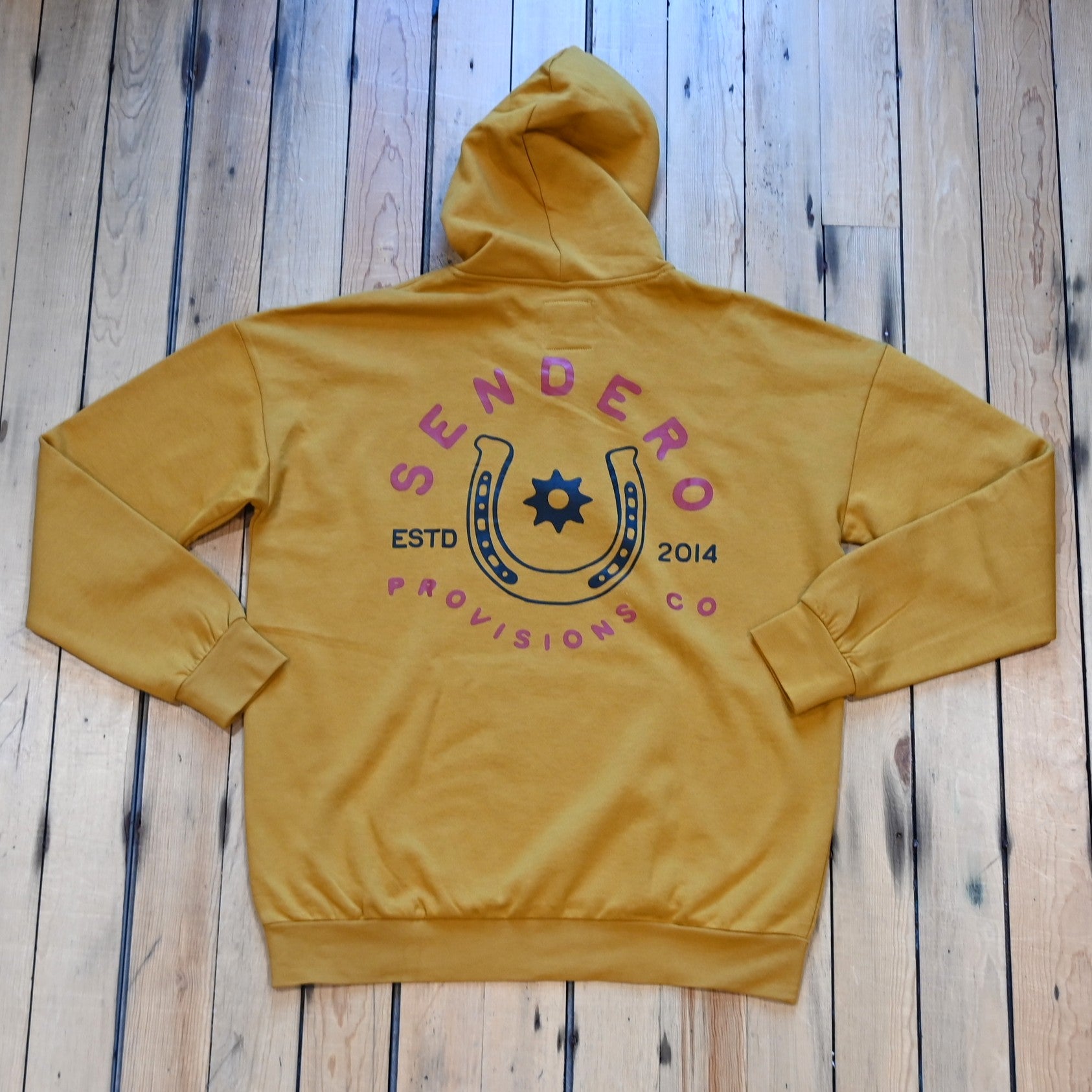 Goldenrod Sendero No Luck hoodie with horseshoe graphic and Sendero Provisions logo