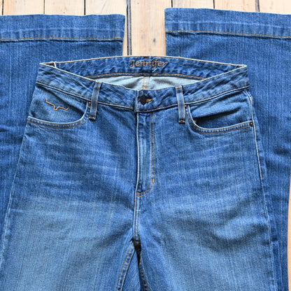 View of Kimes Ranch Jennifer Jeans in Mid Wash featuring a super wide flare leg with hand-sanding and whisker details