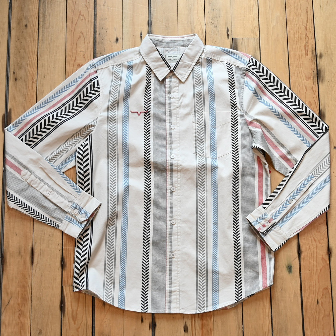 Kimes Ranch Men’s Double Tap Stripe Button-Up Shirt in cream with red, blue, gray, and black vertical stripes