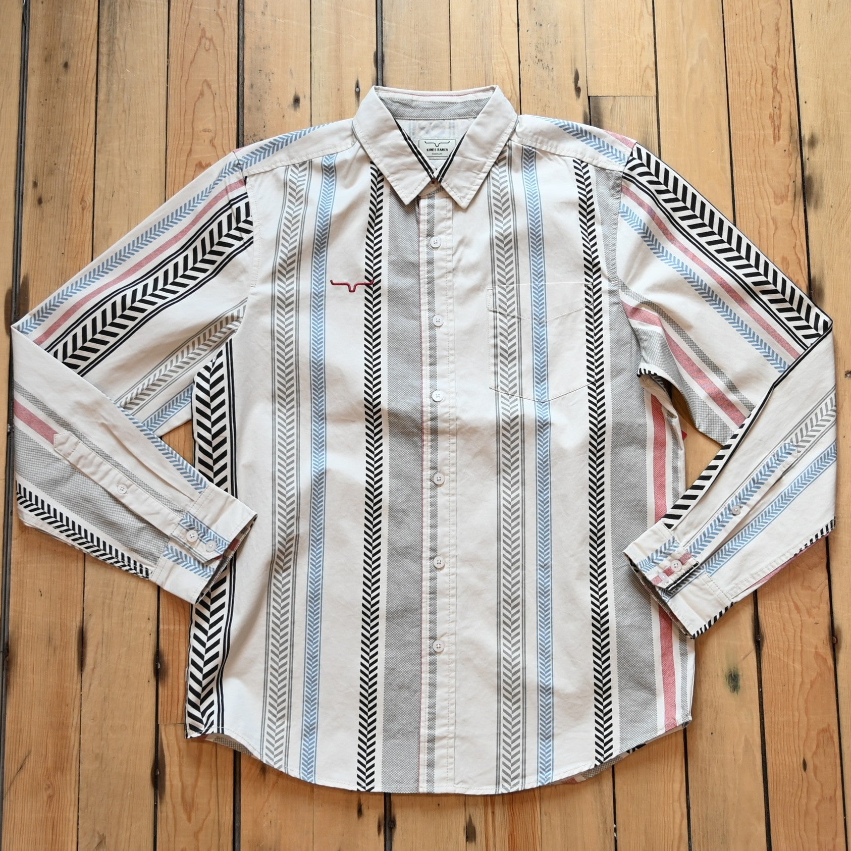 Kimes Ranch Men’s Double Tap Stripe Button-Up Shirt in cream with red, blue, gray, and black vertical stripes