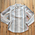 Kimes Ranch Men’s Double Tap Stripe Button-Up Shirt in cream with red, blue, gray, and black vertical stripes
