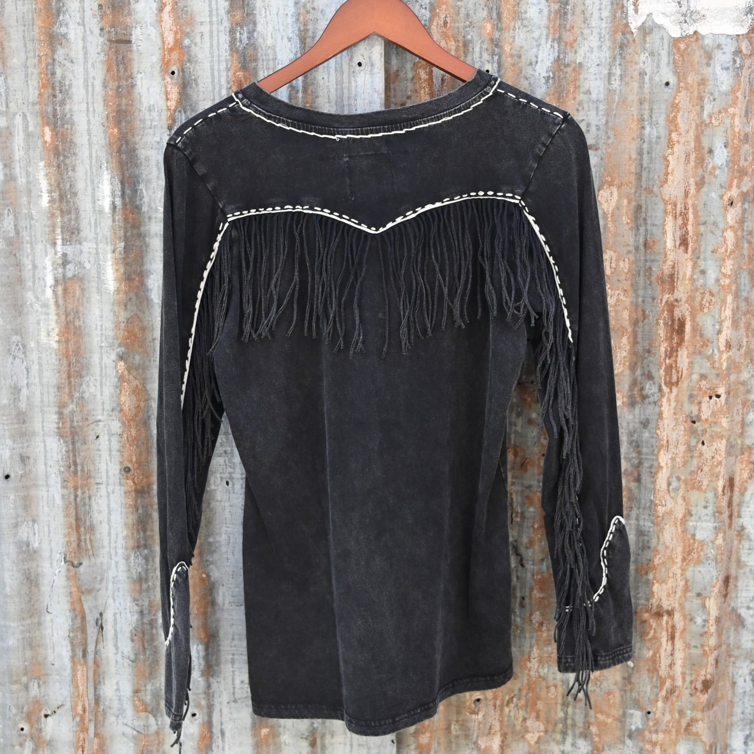 View of Double D Ranch Wild Like the West Tee featuring bold graphic and fringe detailing on long sleeves