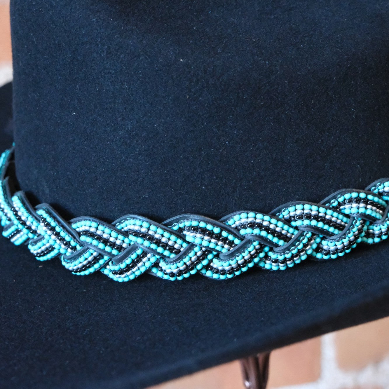 Sambboho Saint Barth hatband featuring blue and silver beads on a braided black full-grain leather base.