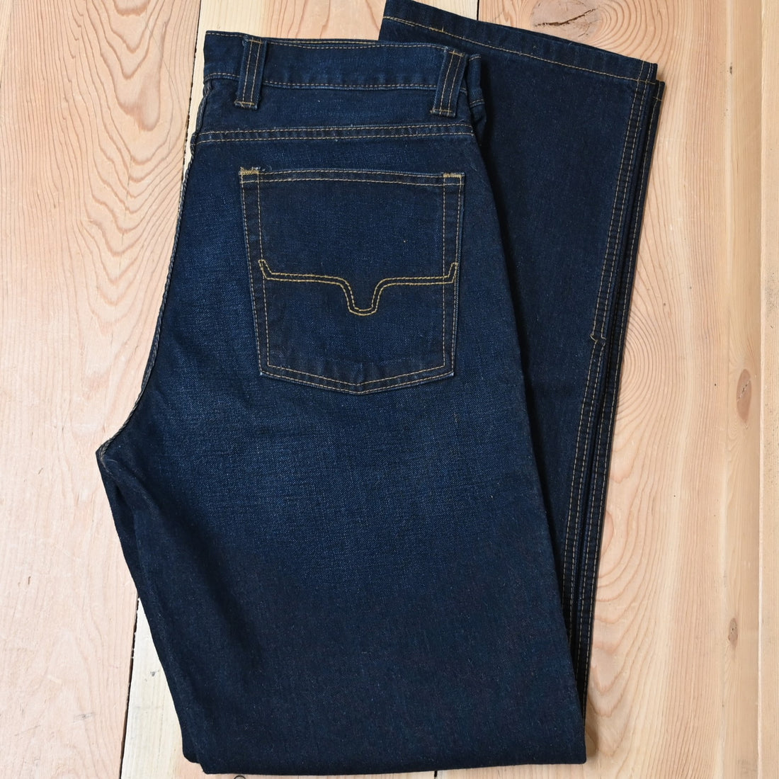 View of Kimes Ranch Watson jeans in Dark Indigo featuring hand-sanded details and bootcut leg