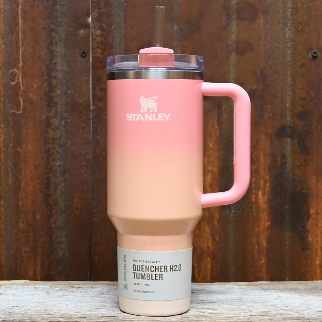 Stanley 40oz Quencher 2.0 FlowState tumbler in Mesa Sunset gradient with handle and straw.