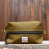 View of Filson Tin Cloth Travel Kit in Dark Tan, showcasing durable waxed cotton exterior and practical design for travel essentials