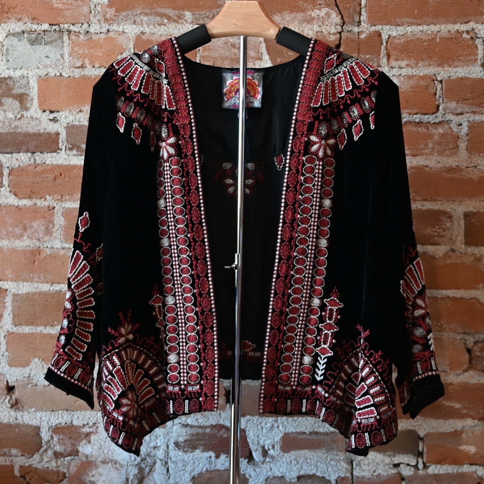 View of Johnny Was black velvet bolero with red and white embroidered floral trim