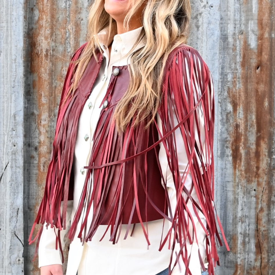 View of Double D Ranch Sonora Vest in Banjo Burgundy featuring full-length fringe and tonal leather lacing details