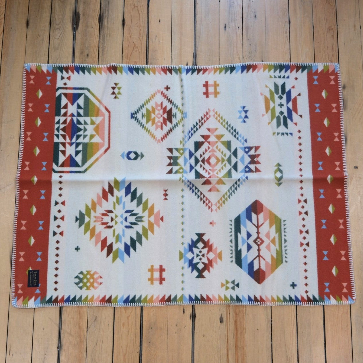 Pendleton Wild Blooms child-sized wool blanket in White/Coral Multi floral design.