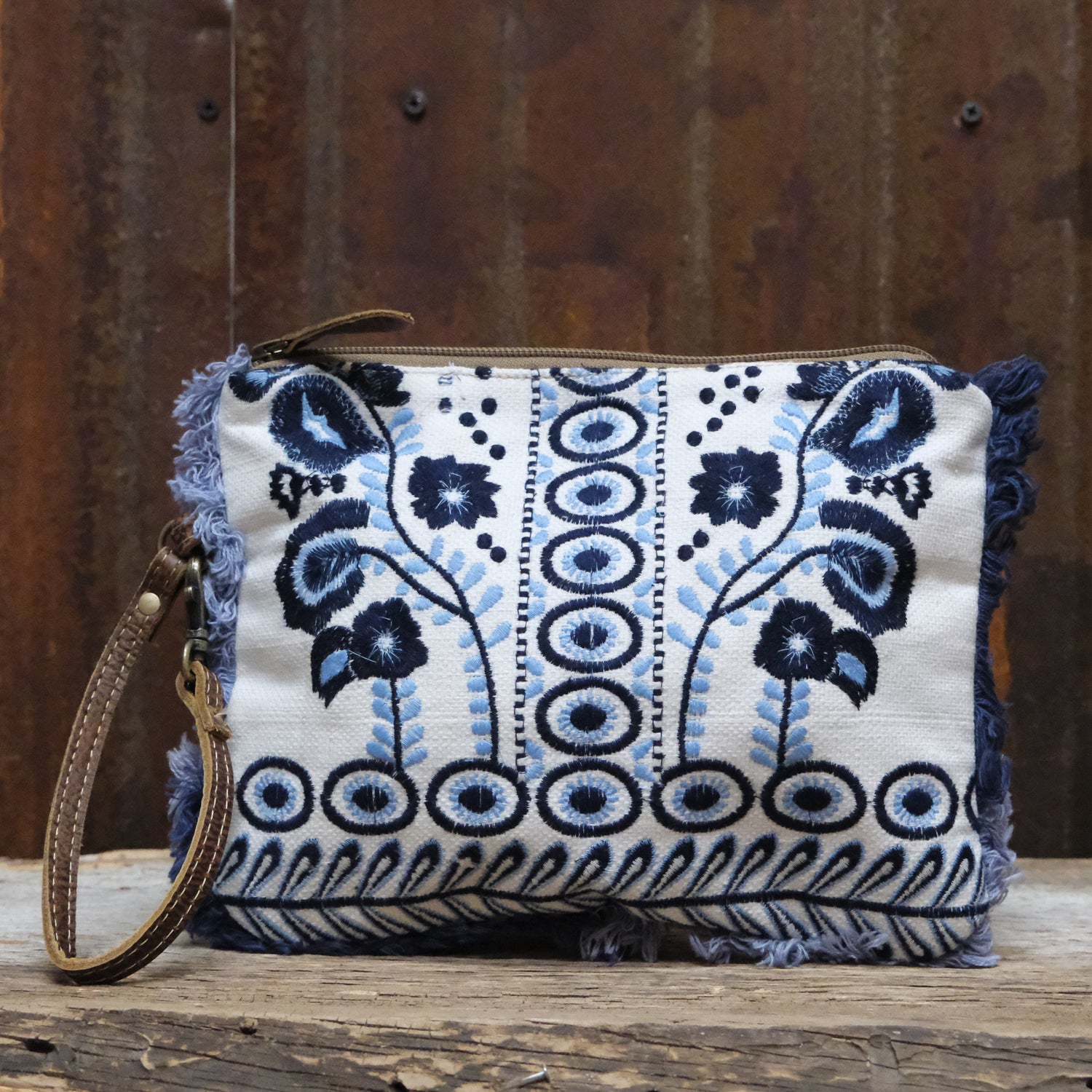 Myra artisanal blue embroidered canvas pouch with leather trim and zipper closure