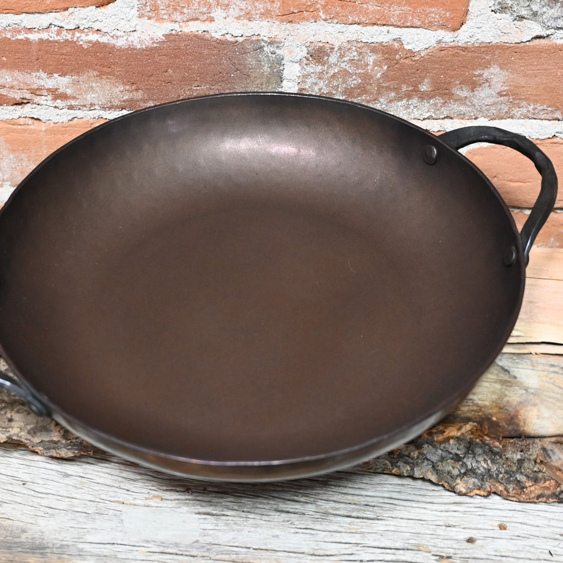 View of Smithey 12&quot; Carbon Steel Round Roaster – Hand-forged pan with hammered handles and pre-seasoned interior