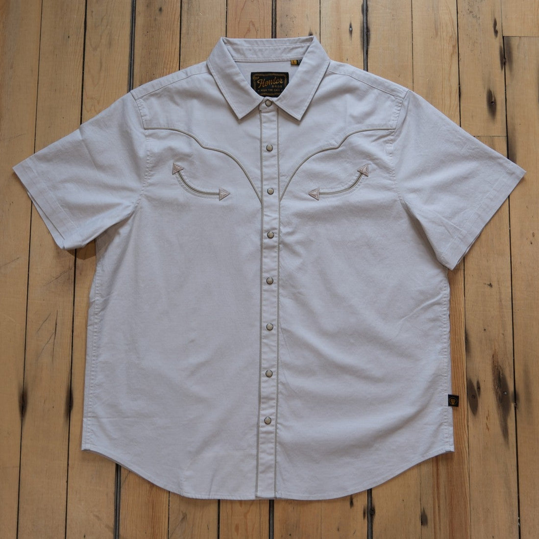 Howler Bros Broncbuster short-sleeve snapshirt in Sand with contrast piping.
