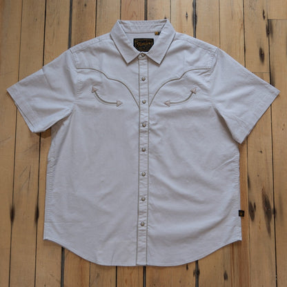 Howler Bros Broncbuster short-sleeve snapshirt in Sand with contrast piping.