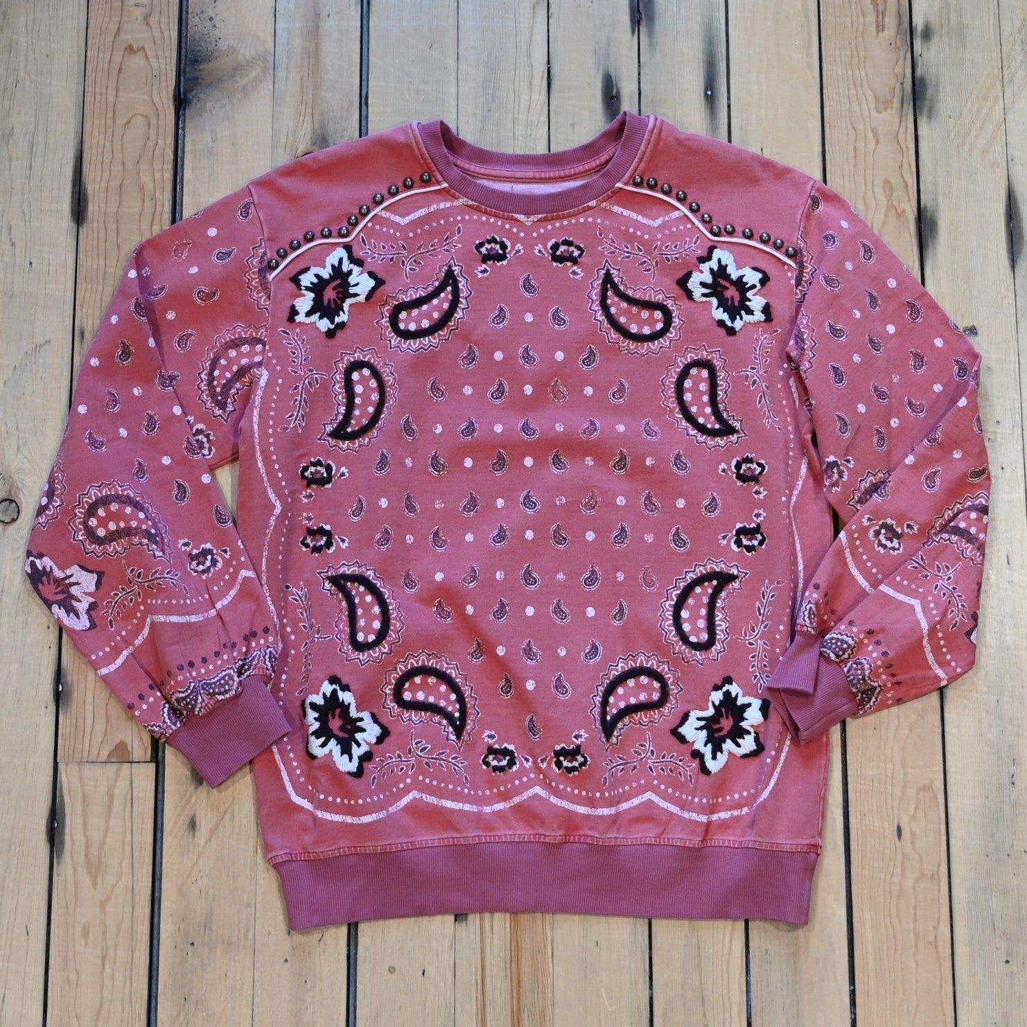 View of Ladies bandana sweatshirt in muted mahogany with embroidered and studded bandana print
