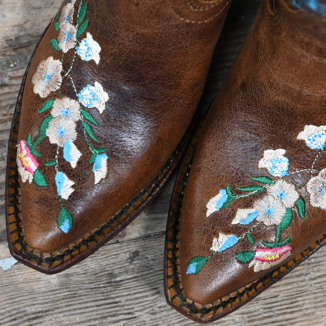 View of Macie Bean youth Honey Bunch boot with floral top, pointed toe, and cowgirl heel
