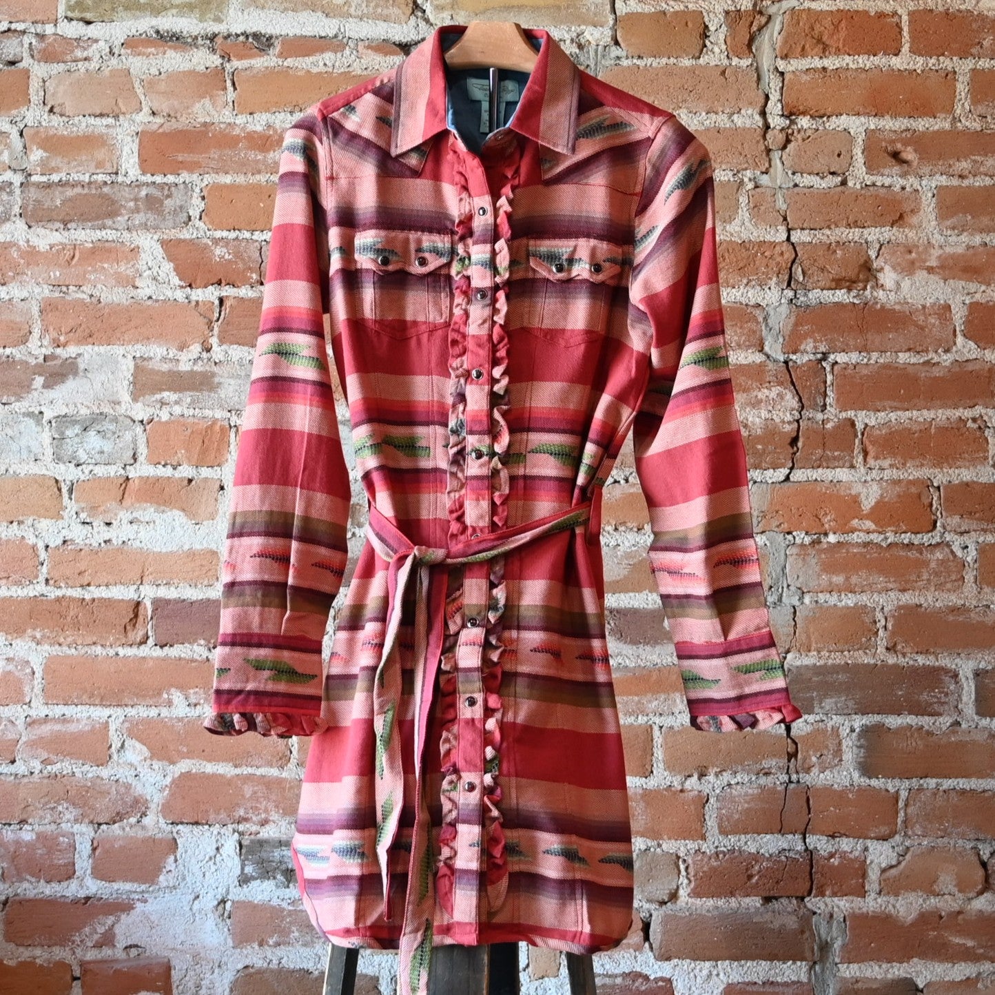 Ladies Colt 44 Tunic in rouge serape pattern with pearl snaps, self-tie belt, collar, and double breast pockets