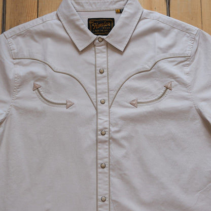 Howler Bros Broncbuster short-sleeve snapshirt in Sand with contrast piping.
