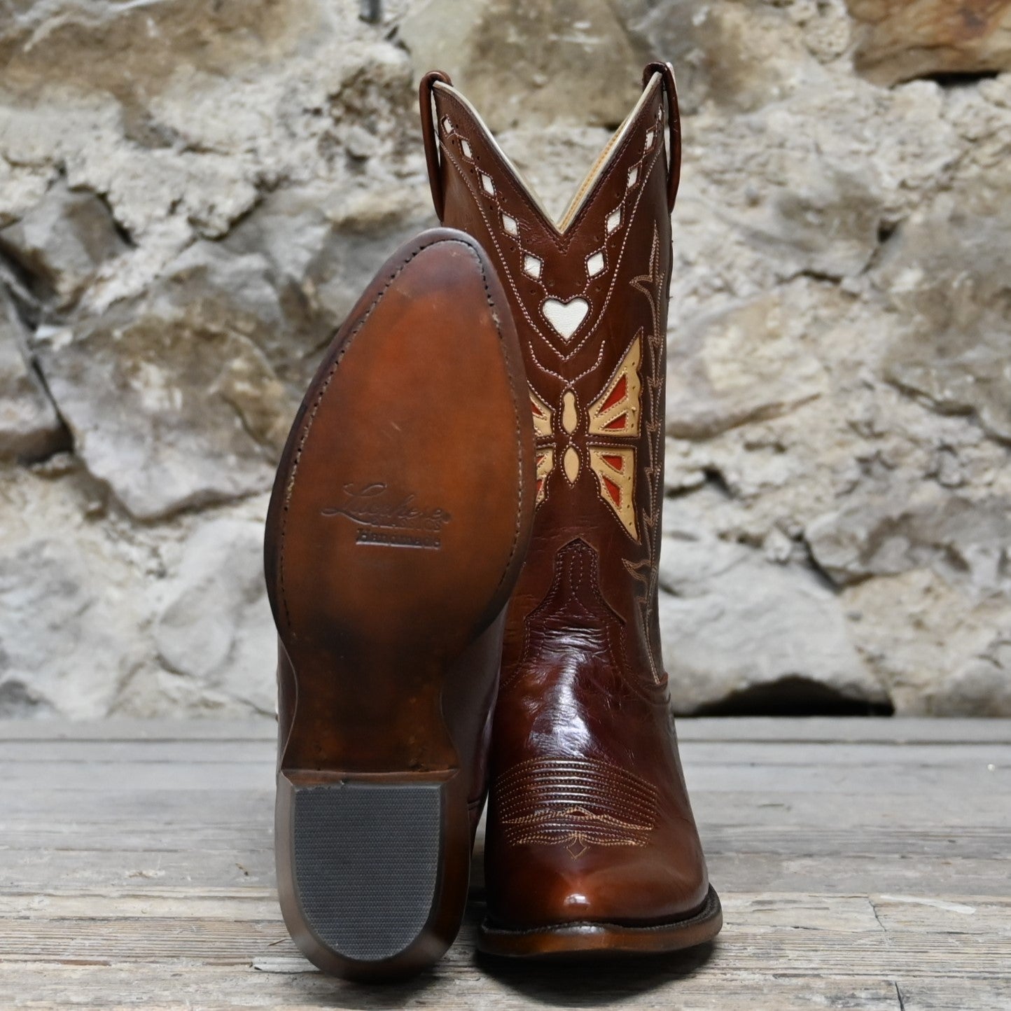 View of Lucchese ladies 12″ whiskey leather boot with butterfly inlay and sharp rounded toe