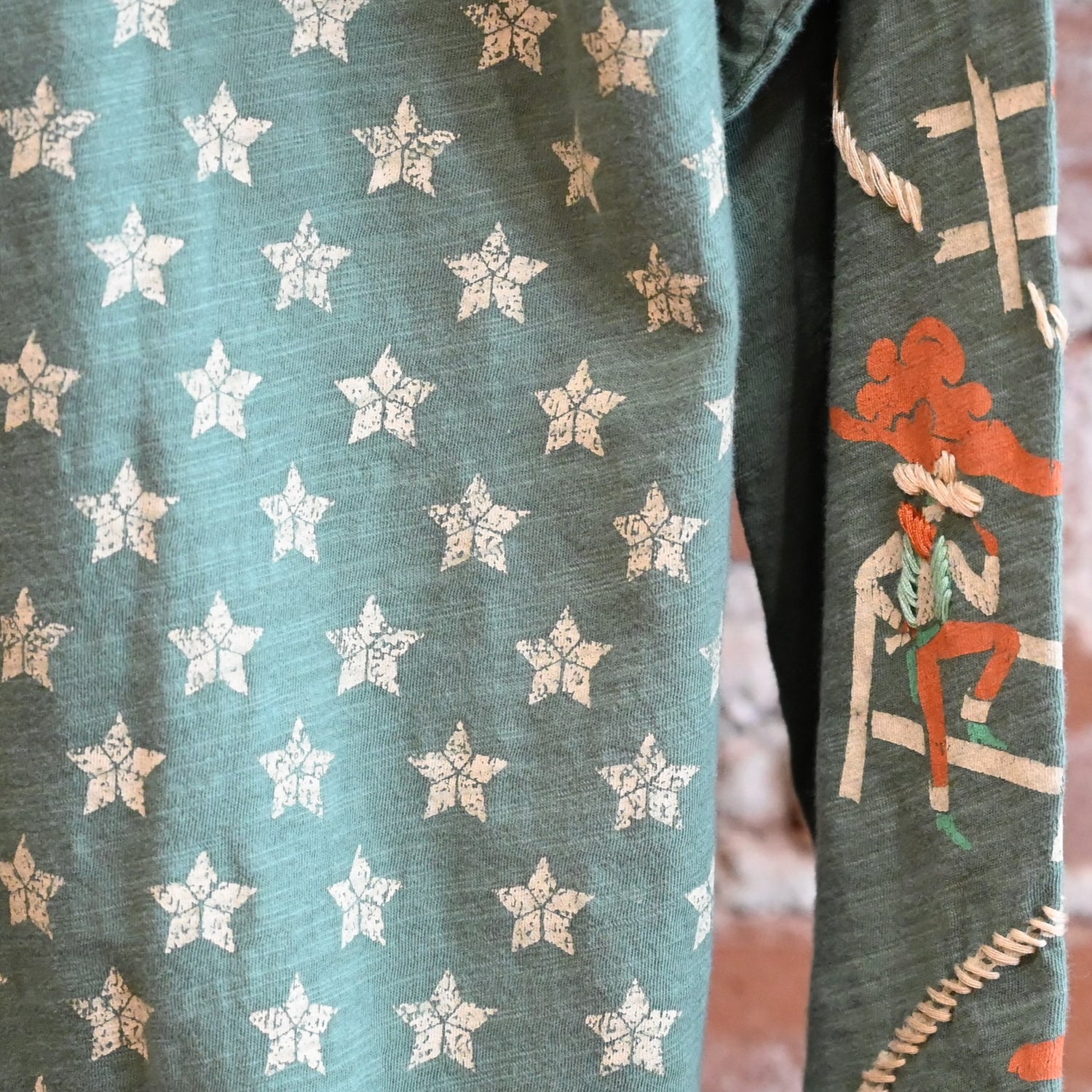 View of Double D Ranch Cowboys Up My Sleeve Top – Button-down top in Garcitas Green with cowboy-inspired print and a relaxed, flattering fit