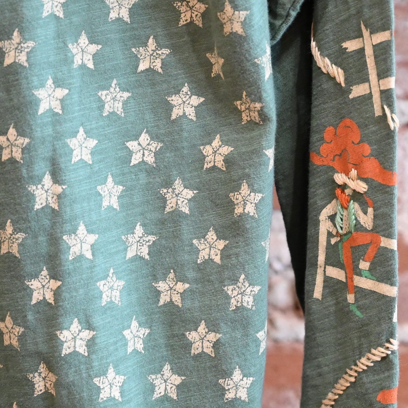 View of Double D Ranch Cowboys Up My Sleeve Top – Button-down top in Garcitas Green with cowboy-inspired print and a relaxed, flattering fit